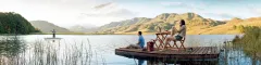 Tours and Safaris to Picturesque view of a couple sitting on a jetty in a tranquil lake in Kwa Zulu Natal